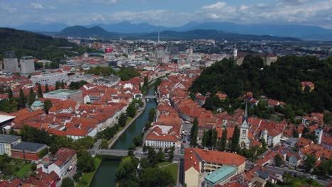 Filmische-4K-Luftaufnahme-Der-Altstadt-Von-Ljubljana-Und-Der-Burg-Von-Ljubljana-Mit-Bergen-Im-Hintergrund