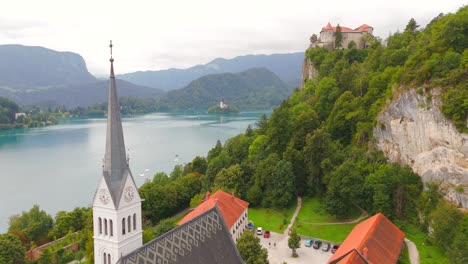 Stunning-drone-footage-of-Lake-Bled,-Slovenia,-showcasing-the-iconic-island,-castle,-and-lush-landscapes