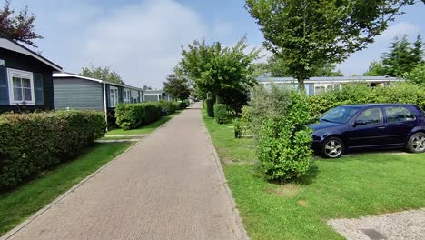 Moving-Shot-of-a-man-walking-across-a-trailer-park