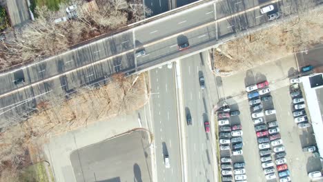 aerial-of-cars-driving-on-highway-through-Plainfield,-New-Jersey-in-the-winter