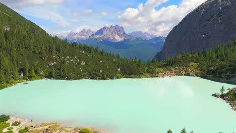 Lake-Sorapis,-nestled-in-the-Dolomites-of-Italy,-is-renowned-for-its-stunning-turquoise-waters,-surrounded-by-majestic-mountains-and-lush-forests,-offering-breathtaking-views-and-serene-tranquility