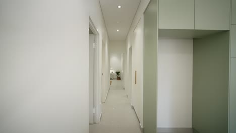 Sleek-modern-hallway-leading-to-a-bedroom-in-a-luxury-small-home,-featuring-minimalist-design-elements