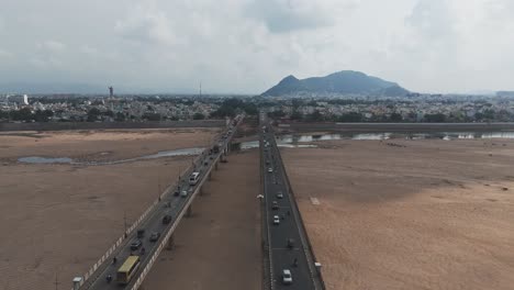 Panoramic-view-of-a-busy-bridge-with-on-going-traffic-over-krishna-river-dried-in-Vijayawada