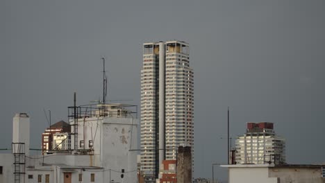 Tall-modern-skyscraper-amid-older-rooftops-in-Buenos-Aires-under-an-overcast-sky