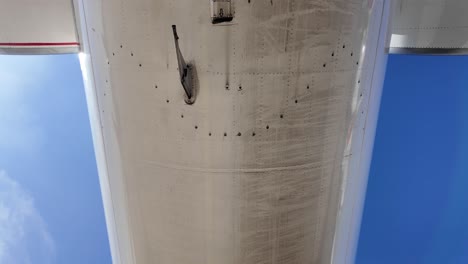 External-rear-view-of-the-fuselage-of-a-white-color-medium-size-jet,-tilting-down-on-the-ramp