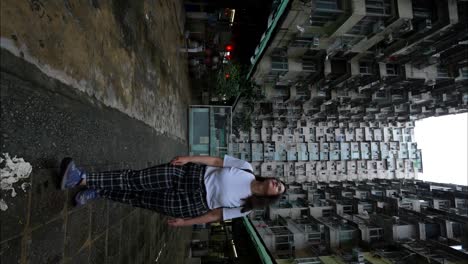 Woman-walks-backwards-looking-at-Monster-Building-in-Hong-Kong