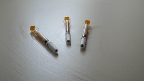 Three-syringes-on-its-containers