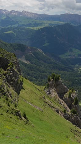 Vertical-View-Of-Rugged-Mountains-With-Green-Forests-At-Suumertime