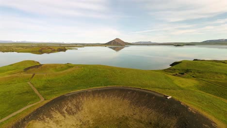 Enjoy-a-breathtaking-aerial-journey-over-Skútustaðagígar,-revealing-the-intricate-patterns-and-natural-beauty-that-define-this-iconic-Icelandic-landmark