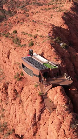 Vertical-Drone-Shot-of-Modern-House-on-Sandstone-Cliff,-Futuristic-Villa-With-Solar-Panels,-Sedona-Arizona-USA