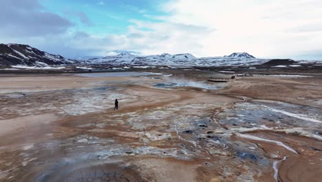 Behold-the-majestic-sight-of-sulfuric-smoker-landscape-near-Myvatn-at-Reykjahlid-in-Iceland,-with-billowing-smoke-and-a-majestic-mountain-range-in-the-background