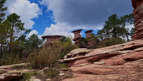 Timelapse-of-sky-with-clouds-next-to-strangely-shaped-rock-formations