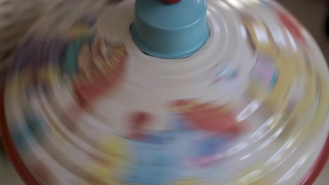 A-colorful-spinning-toy-top-in-motion-creating-a-blur-of-vibrant-patterns-and-colors