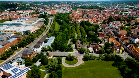 4K-Aerial-Drone-Video-of-Rezatparkplatz-West-Parking-Lot-along-the-Frankische-Rezat-River-in-Ansbach,-Germany