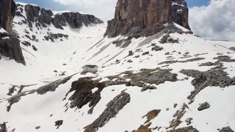 Aerial-Drone-Shot-on-House-in-the-mountain-in-a-snowy-valley-Pisciadù-Hut-in-Alta-Badia