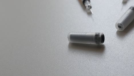 Close-up-shot-of-syringes-and-containers