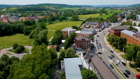 4K-Aerial-Drone-Video-of-Businesses-along-the-Frankische-Rezat-River-in-Ansbach,-Germany