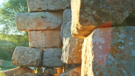 Close-up-view-of-ancient-stone-blocks-basking-in-the-warm-sunlight,-showcasing-the-texture-and-weathering-of-the-historical-structure