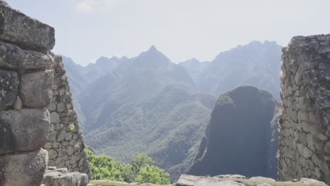 Panning-of-Machu-Picchu-mountains-landscape-between-stone-walls-ruins-lost-city-citadel