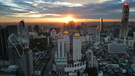 Bangkok-Thailand's-skyscrapers-aerial-sunset-view-of-commercial-area-corporate-road