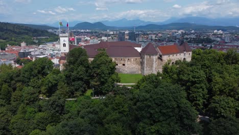 Aerial-view-of-Ljubljanski-Grad-from-close-up---Ljubljana-Castle-with-city-in-background