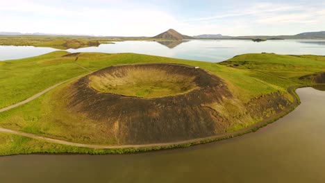 Witness-the-mesmerizing-shapes-of-Skútustaðagígar-from-above,-where-volcanic-activity-has-sculpted-an-extraordinary-landscape-filled-with-history-and-beauty