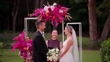 Happy-Bride-And-Groom-Smiling-With-Celebrant-At-Altar-For-Outdoor-Wedding-Ceremony,-4K-Slow-Motion