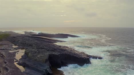 Misty-sunset-at-Bridges-of-Ross-with-waves-crashing-along-the-coastline