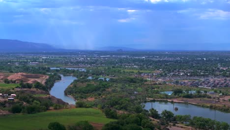 Colorado-River-summer-Grand-Junction-aerial-drone-Grand-Mesa-downtown-Main-Street-circle-left-motion-afternoon-cloudy-blue-sky-wine-vineyards-Parachute-Fruitvale-Mt-Garfield-Western-Close-Delta-USA