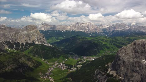 Colfosco-village-in-Alta-Badia,-surrounded-by-lush-valleys-and-towering-Dolomite-peaks