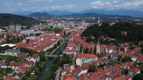 4K-Cinematic-drone-aerial-view-of-Ljubljana-Old-Town-and-Ljubljana-Castle-with-mountains-in-the-background