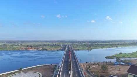 Modern-highway-bridge-over-river-in-Indonesia,-aerial-view