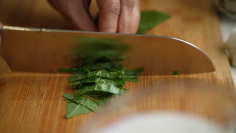 Chef-cutting-leaves-to-be-used-at-recipe-using-knife