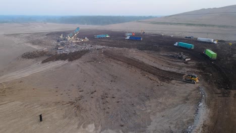 Landfill-site-with-trucks-unloading-waste-in-a-large-open-area,-Michigan,-USA,-garbage-and-refuse-from-Canada-is-shipped-to-Michigan