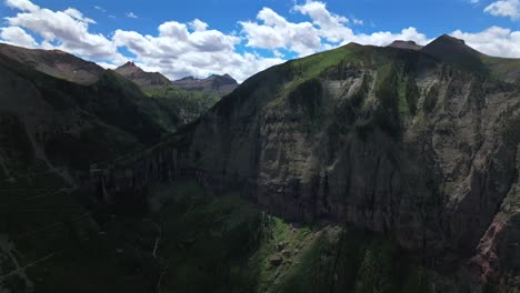 Yankee-Boy-Basin-Colorado-Black-Bear-Pass-Road-dirt-road-4wd-hiking-blue-sky-cliffside-valley-aerial-drone-Ouray-Ridgway-Telluride-summer-Box-Canyon-Bridal-Veil-Falls-Aspen-Forest-pan-left