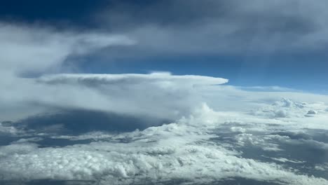 Immersive-pilot-POV-FPV-from-the-cockpit-of-a-jet-flying-at-cruise-level-through-a-stormy-sky-with-a-huge-cumulonimbus-storm-cloud-ahead