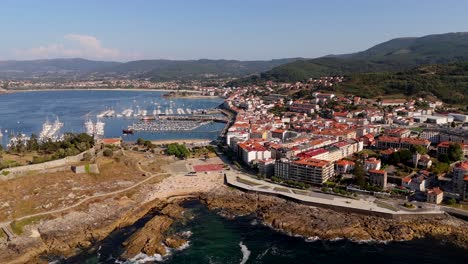 Aerial---mini-beach-and-Bayona's-town-center-along-Galician-coast,-Spain