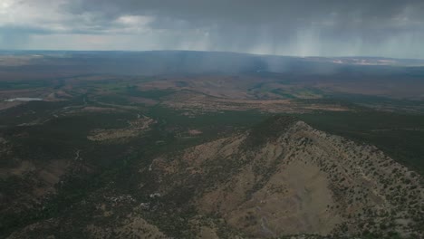 Raining-Lands-End-Hill-Climb-Grand-Mesa-Grand-Junction-Colorado-aerial-drone-summer-morning-clouds-thunderstorm-rain-sunny-Western-Slopes-Delta-Montrose-Olathe-shade-dark-forward-pan-up-motion