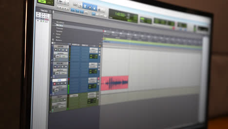 Audio-editing-software-displayed-on-a-computer-monitor-in-a-professional-recording-studio