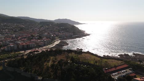 Aerial-of-Bayona,-Galicia,-Spain,-overlooking-the-coastal-town-and-shimmering-ocean