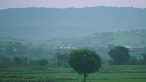 Indian-railways-passenger-train-passing-through-green-hills-in-North-Central-India