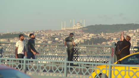 Man-standing-near-fence-against-a-background-of-Istanbul-skyline-view