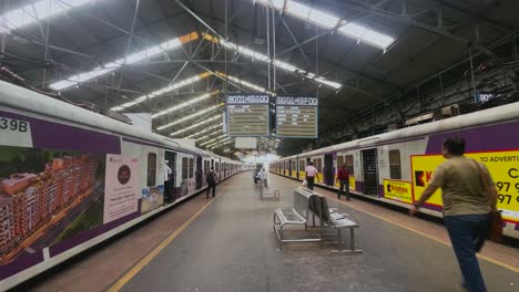 Passengers-and-commuters-running-for-local-train-on-Churchgate-station-with-digital-display-boards