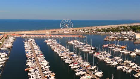 The-aerial-views-of-Rimini-capture-the-lively-beach-atmosphere,-with-vibrant-umbrellas-and-sunbathers-enjoying-the-sun,-creating-a-perfect-summer-escape