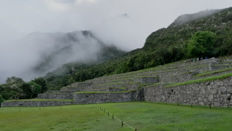 Tourists-walk-over-Machu-Picchu-stone-terraces