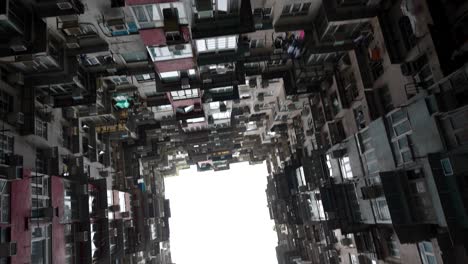 Tilt-up-view-of-dense-urban-living-at-Yick-Cheong-Building,-Monster-Building,-Hong-Kong