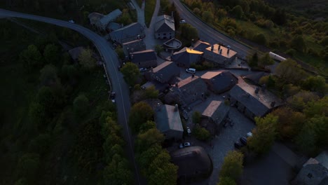 Aerial-ascending-shot-of-Picturesque-Cebreiro-town-surrounded-by-mountains-at-Sunset,-Lugo