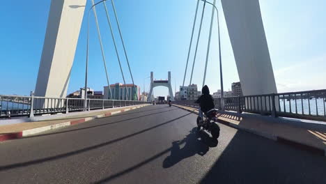 Vietnam-Travel-And-Tourism:-Bikers-Crossing-Over-The-Ca-Ty-River-On-The-Famous-Approaching-The-Urban-City-Center-And-Marketplace-Of-Binh-Thuan,-Vietnam