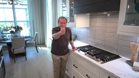 happy-customer-in-the-kitchen-shows-off-the-tile-backsplash-on-his-new-home