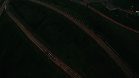 Aerial-view-of-a-commercial-truck-driving-at-night-on-a-interstate-road-connection